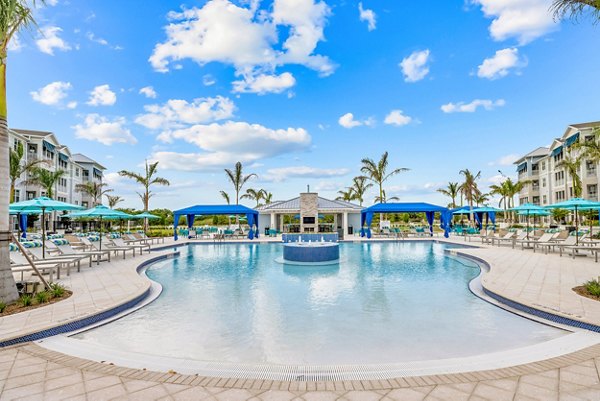 Poolside relaxation area at Encore at Tradition Apartments with luxury features