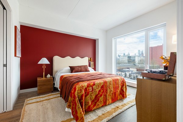 Spacious bedroom with modern decor at The Noble Apartments, luxury living by Greystar