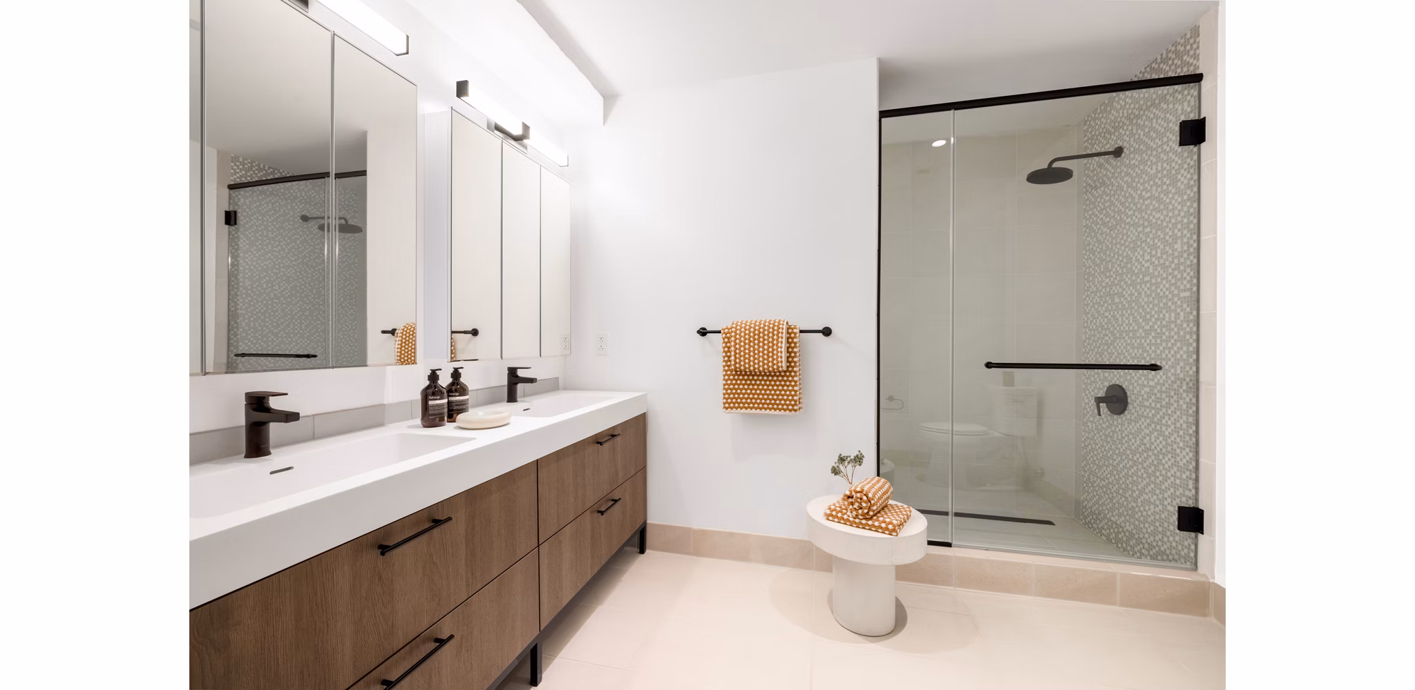 Elegant bathroom with marble countertops at The Noble Apartments