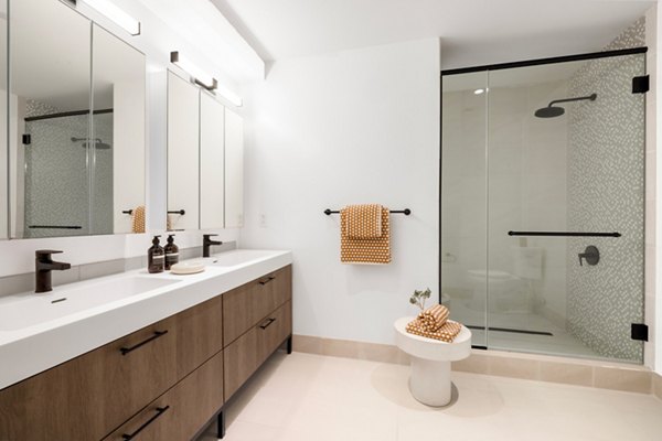 Elegant bathroom with marble countertops at The Noble Apartments