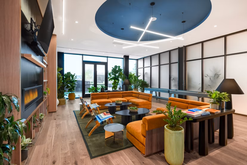 The Noble Apartments: Elegant clubhouse with modern decor and ample seating, ideal for luxury living experiences in a vibrant community setting