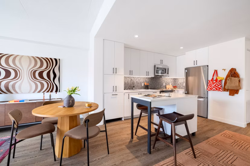 Dining area with modern furniture and stylish lighting in The Noble Apartments, luxury living by Greystar