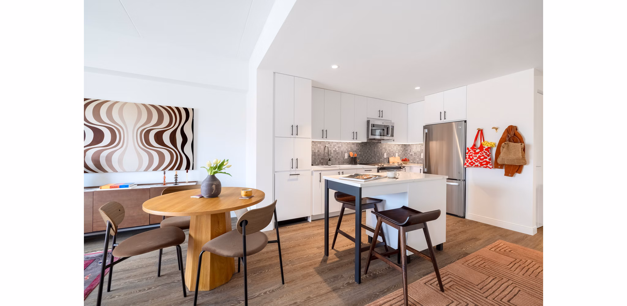 Dining area with modern furniture and stylish lighting in The Noble Apartments, luxury living by Greystar