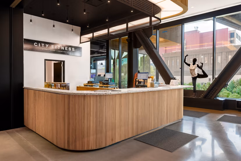 Modern fitness center with state-of-the-art equipment at The Noble Apartments, offering a comprehensive workout experience for residents