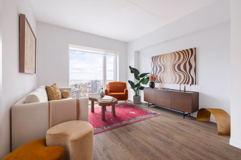 Modern living room with stylish furniture and natural light in The Noble Apartments