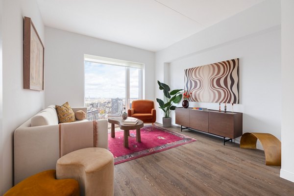 Modern living room with stylish furniture and natural light in The Noble Apartments