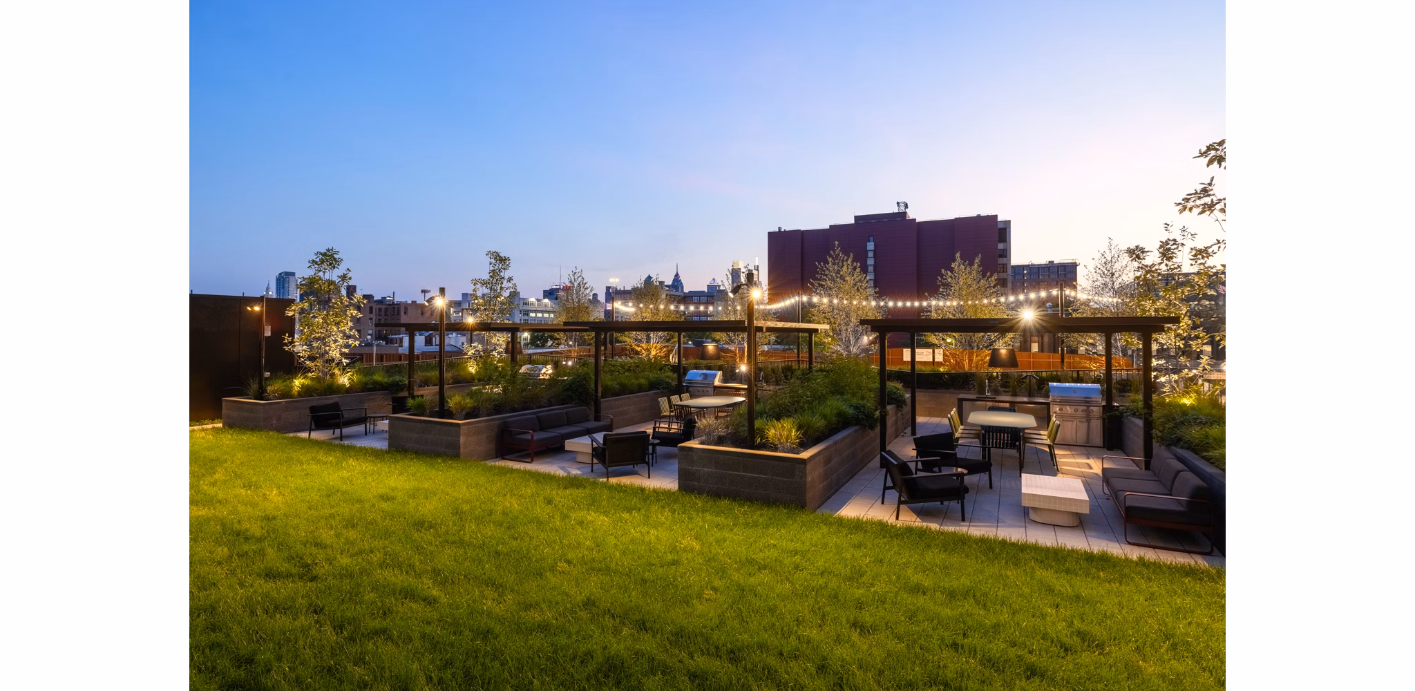Courtyard featuring lush greenery and seating areas at The Noble Apartments' luxury complex
