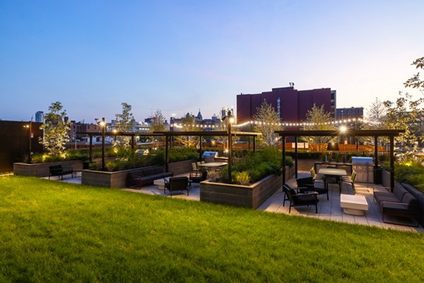 Courtyard featuring lush greenery and seating areas at The Noble Apartments' luxury complex