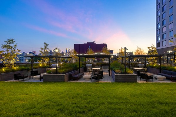 Cozy courtyard with lush greenery at The Noble Apartments, luxury living by Greystar