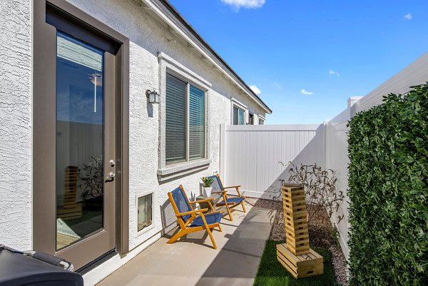 Patio with comfortable seating and lush greenery at Yardly Paradisi Homes, a luxury apartment community