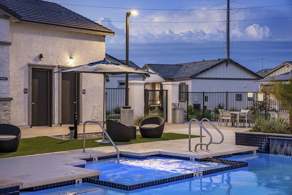 Modern outdoor pool with lounge chairs at Yardly Paradisi Homes luxury apartments, perfect for relaxation and leisure activities