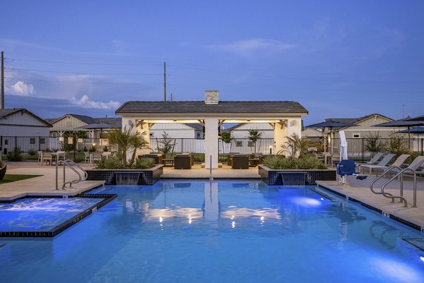 Contemporary outdoor pool with lounge chairs at Yardly Paradisi Homes, offering a luxurious retreat for residents