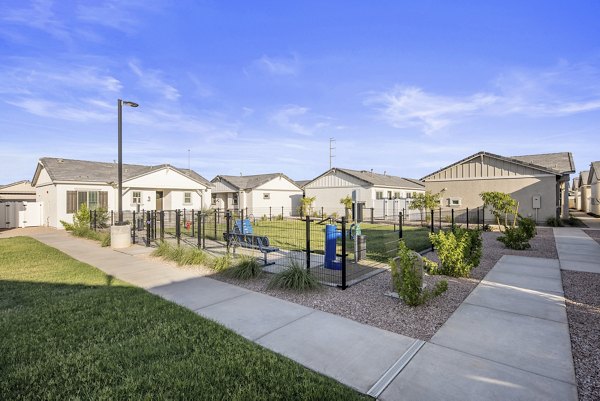 Spacious dog park with agility equipment at Yardly Paradisi Homes apartments