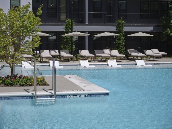 Infinity edge pool at The Eden at Lakeview Apartments with luxurious seating and lake views