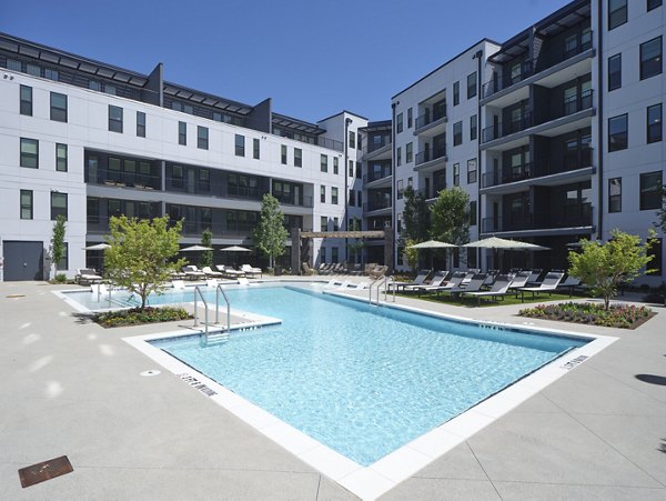 Outdoor pool with sundeck at The Eden at Lakeview Apartments