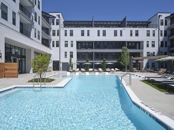 Rooftop pool with sun loungers at The Eden at Lakeview Apartments