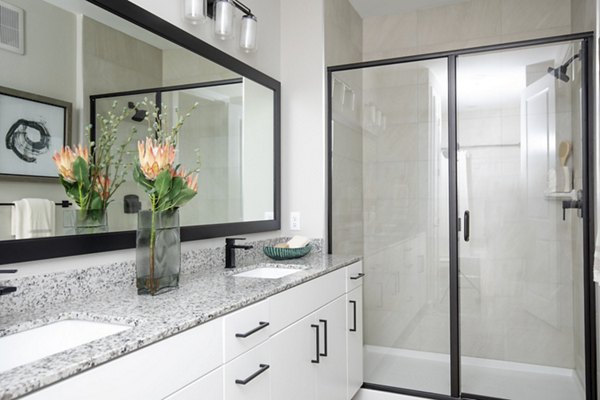 Luxury bathroom with modern fixtures at Eleve Apartments, featuring elegant design and premium finishes