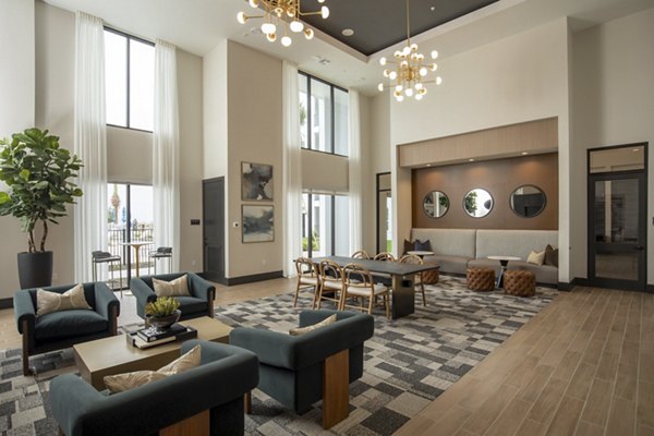 Clubhouse lounge with modern decor at Eleve Apartments, featuring comfortable seating and entertainment options