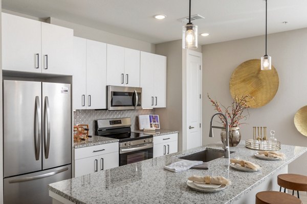 Kitchen with sleek countertops and modern appliances at Eleve Apartments