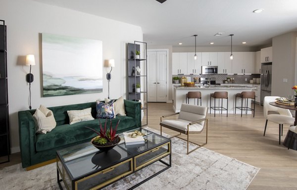 Spacious living room with modern decor and large windows in Eleve Apartments