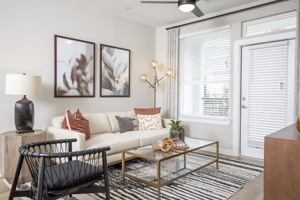 Modern living room with stylish decor in Eleve Apartments for a sophisticated residential experience