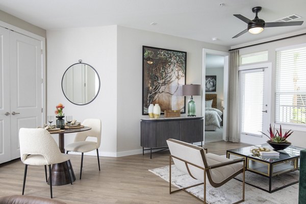Modern living room with stylish furniture and ample lighting at Eleve Apartments