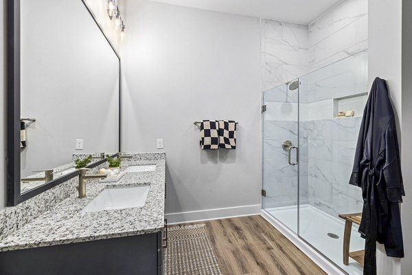 Contemporary bathroom with elegant marble countertops at The Keaton at Brier Creek Apartments