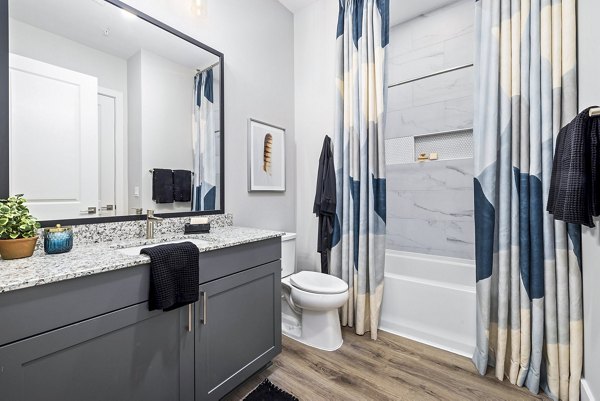 The Keaton at Brier Creek: Elegant bathroom with designer fixtures and marble countertops at luxury apartments