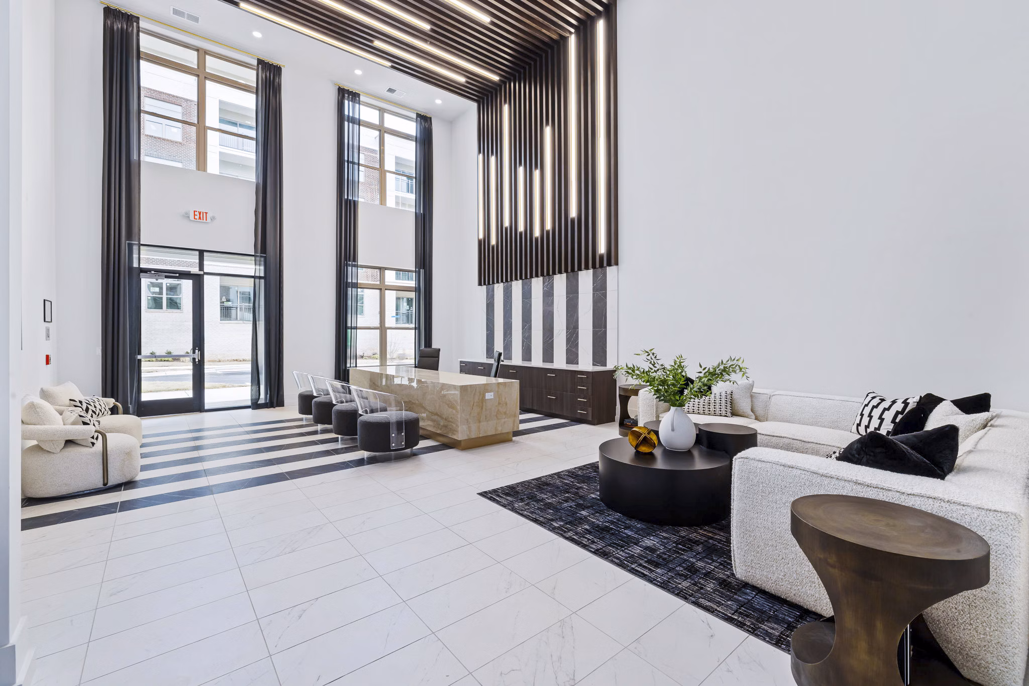 Clubhouse lobby featuring modern decor and comfortable seating at The Keaton at Brier Creek Apartments