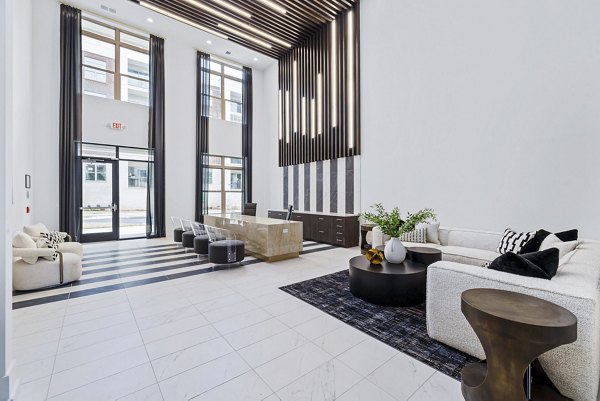 Clubhouse lobby featuring modern decor and comfortable seating at The Keaton at Brier Creek Apartments