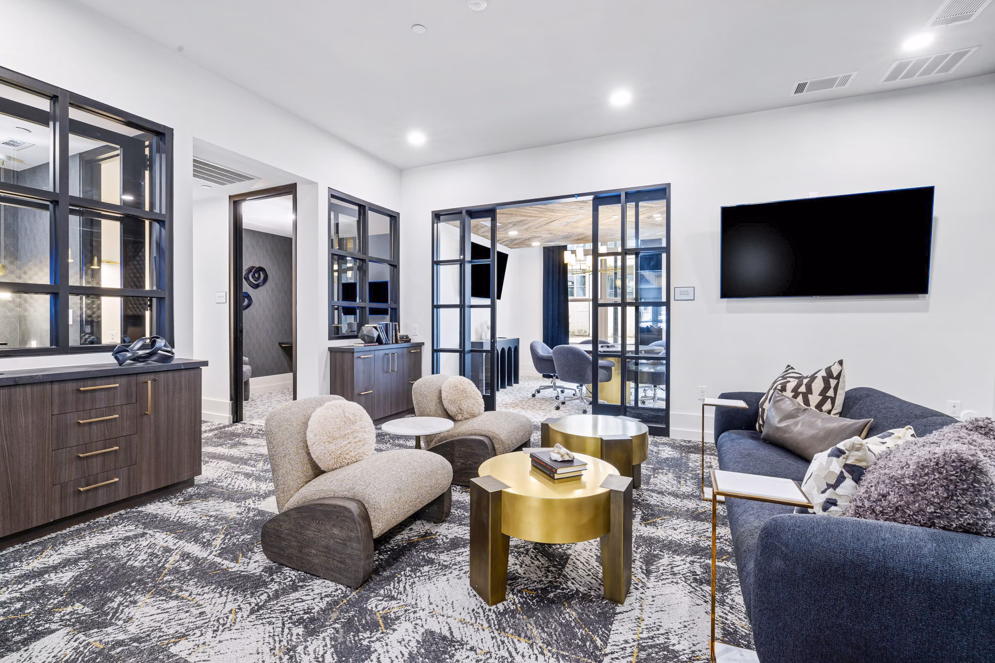 Clubhouse featuring modern lounge seating and billiards at The Keaton at Brier Creek Apartments