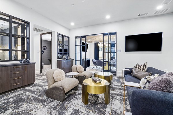 Clubhouse featuring modern lounge seating and billiards at The Keaton at Brier Creek Apartments
