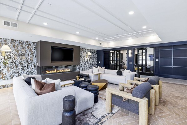 The Keaton at Brier Creek: Modern clubhouse featuring stylish seating and a fireplace in luxury apartments