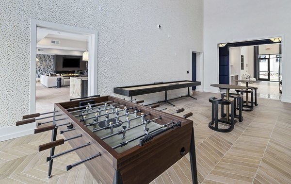 Clubhouse game room with pool table and entertainment area at The Keaton at Brier Creek Apartments