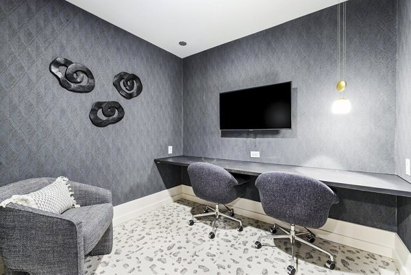 Modern clubhouse business center with workspace at The Keaton at Brier Creek Apartments, offering luxury living comforts
