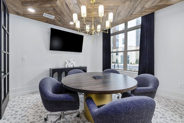 Clubhouse meeting facility with modern seating and audiovisual equipment at The Keaton at Brier Creek Apartments