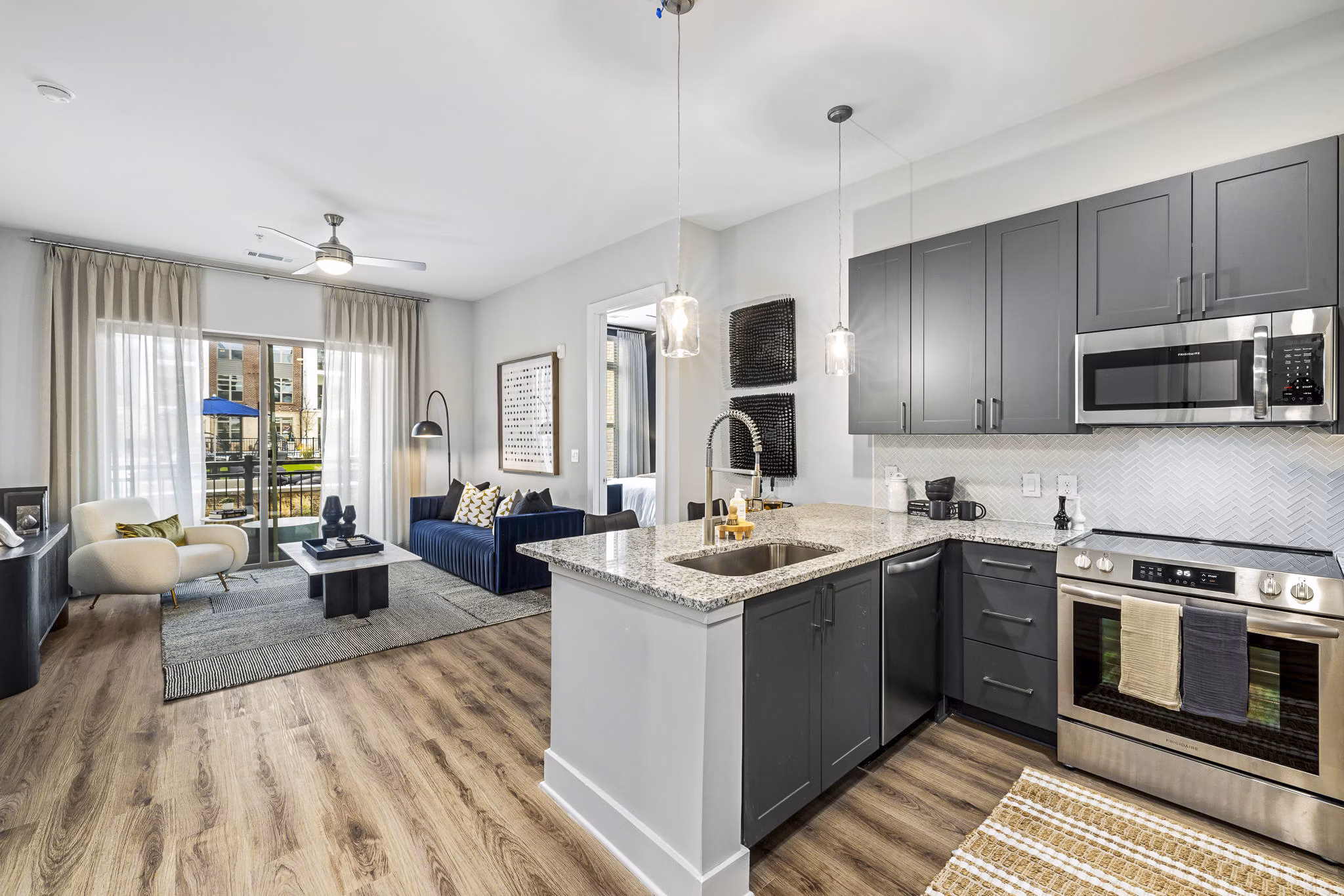 Modern kitchen with stainless steel appliances at The Keaton at Brier Creek Apartments