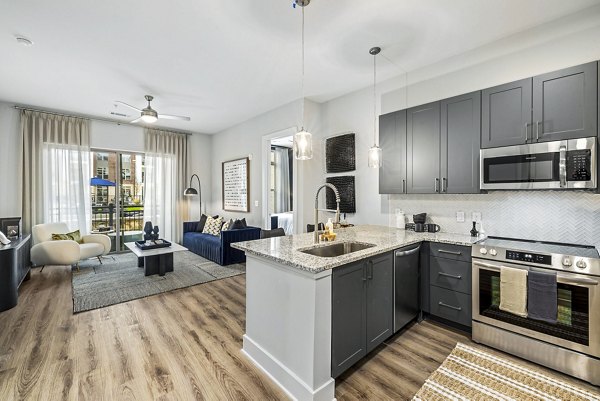 Modern kitchen with stainless steel appliances at The Keaton at Brier Creek Apartments
