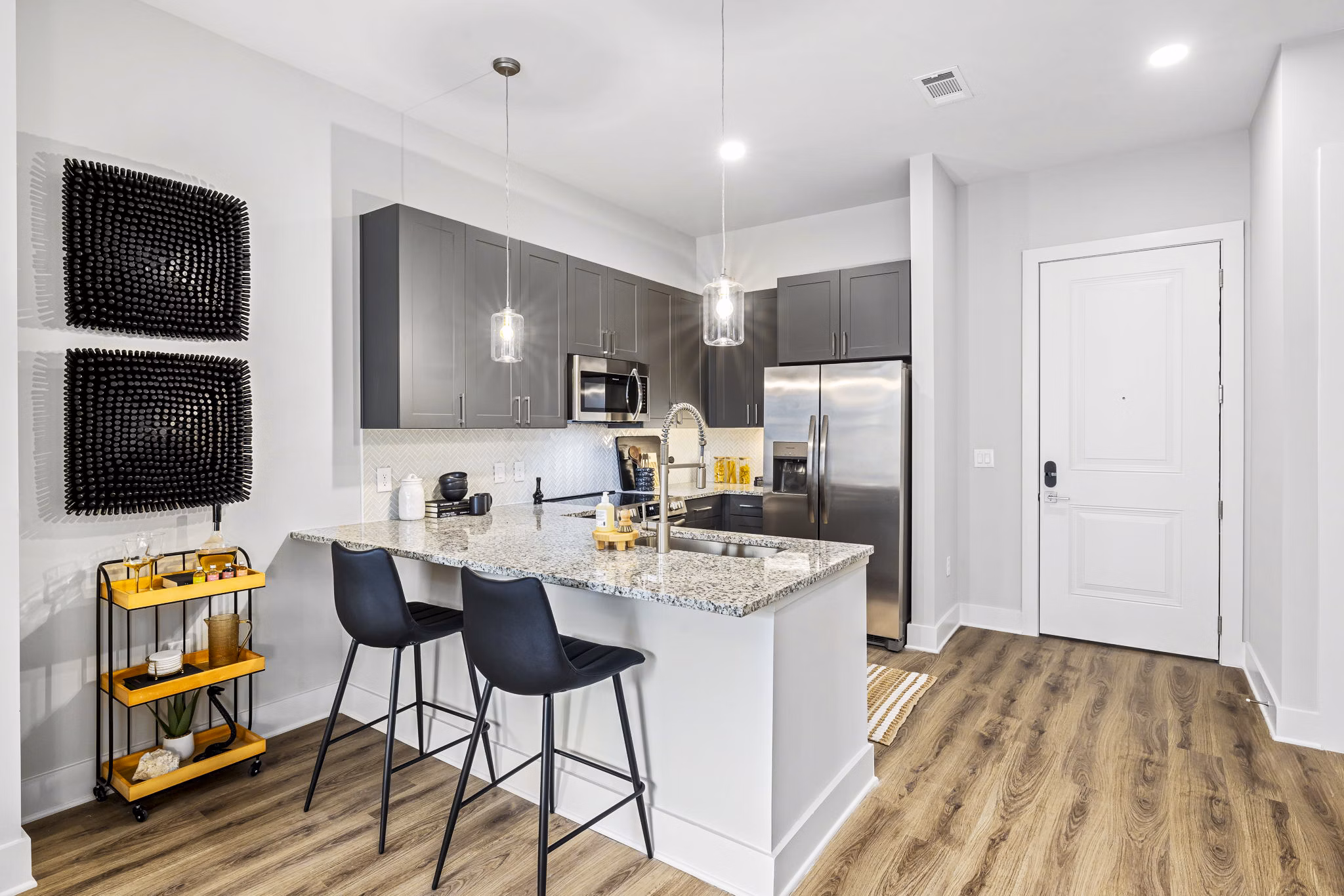 Modern kitchen featuring sleek countertops and stainless steel appliances in The Keaton at Brier Creek Apartments