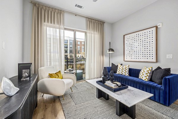 Spacious living room with modern decor at The Keaton at Brier Creek Apartments