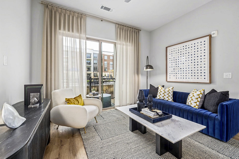 Spacious living room with modern decor at The Keaton at Brier Creek Apartments