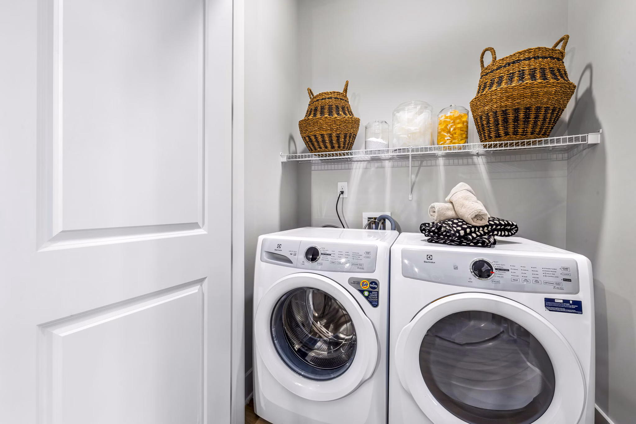 Laundry room featuring modern appliances in Keaton at Brier Creek Apartments