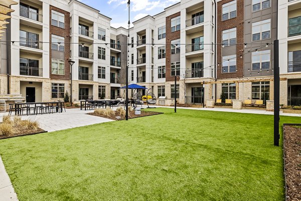 Dog park and patio at The Keaton at Brier Creek Apartments featuring pet-friendly spaces and outdoor seating