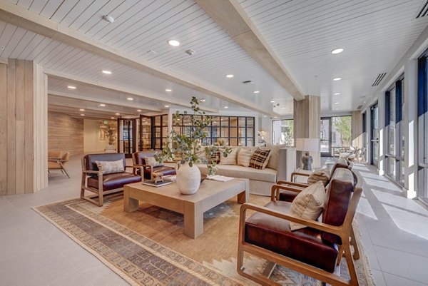 Clubhouse featuring modern design and ample seating at Camber Apartments, a luxury community offering premier amenities
