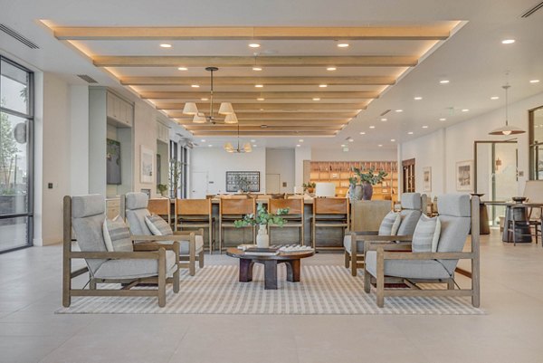 Modern clubhouse featuring sleek furniture and entertainment amenities at Camber Apartments