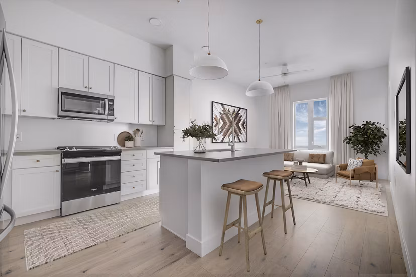 Modern kitchen with stainless steel appliances and granite countertops in Camber Apartments