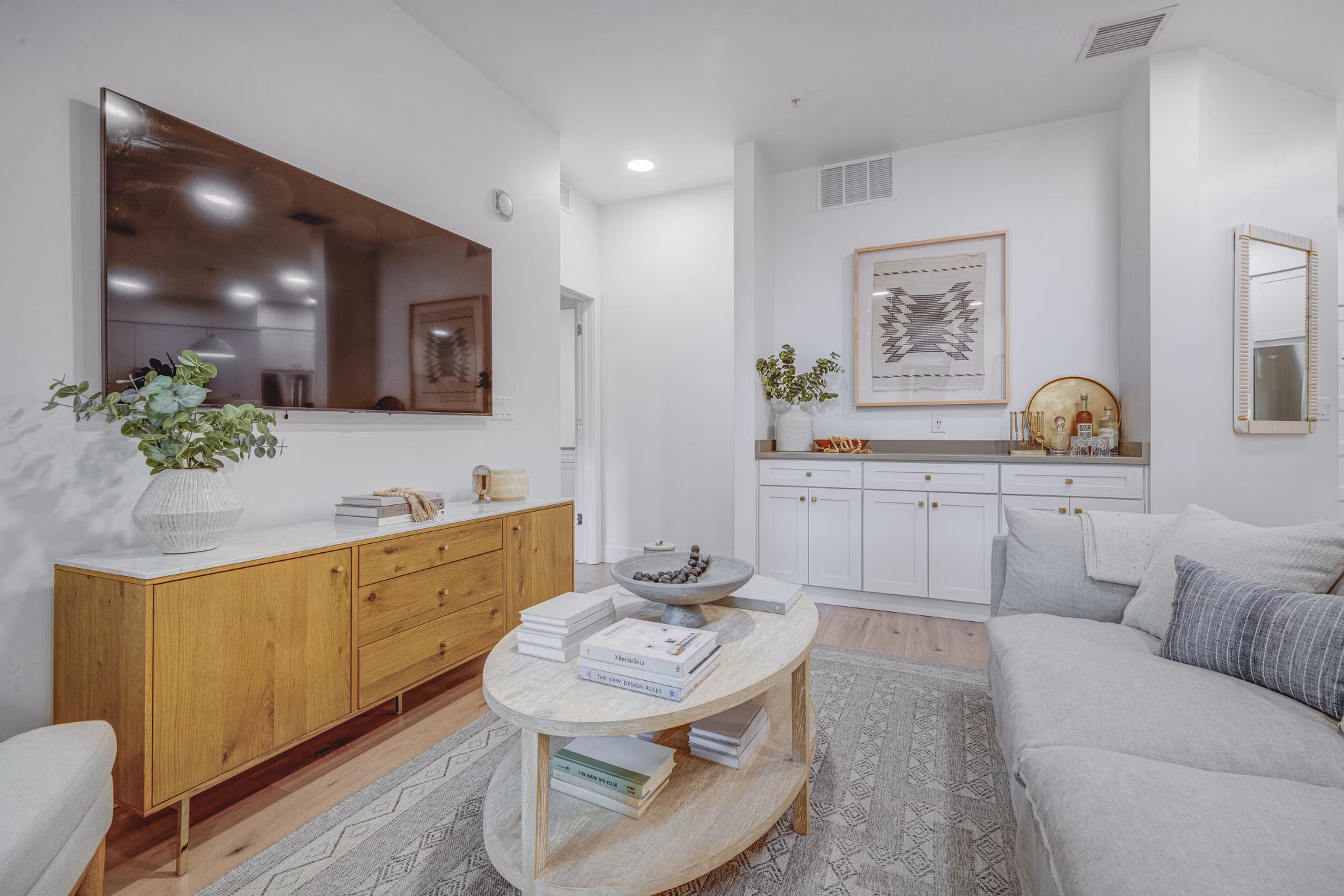 Cozy living room with modern furnishings in Camber Apartments, featuring comfortable seating and stylish decor
