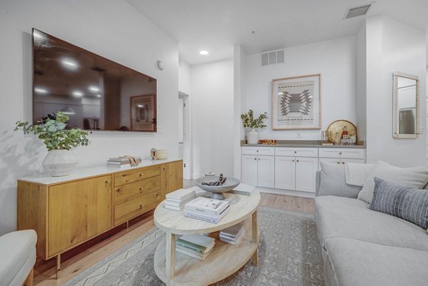 Cozy living room with modern furnishings in Camber Apartments, featuring comfortable seating and stylish decor