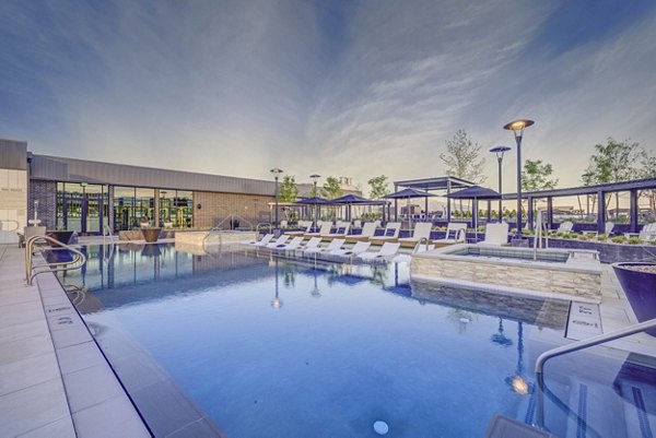 Resort-style pool with lush landscaping at Camber Apartments, offering luxury living amenities