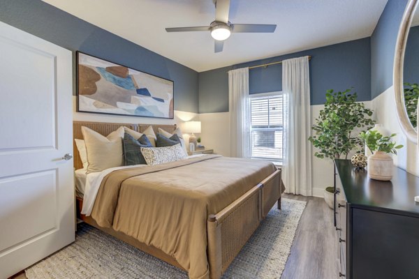 Modern bedroom with sleek furnishings at Alton Serenoa Apartments